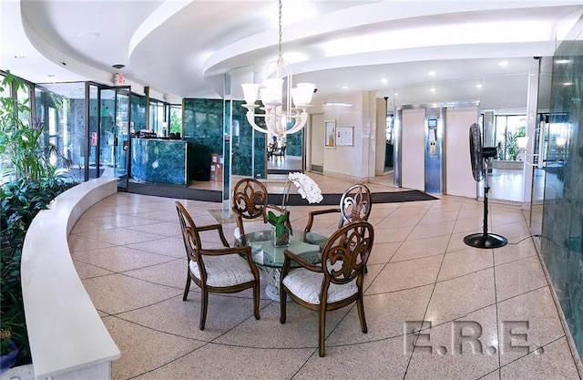 dining room with a tray ceiling, a notable chandelier, and french doors