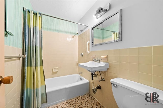 full bathroom featuring toilet, tile walls, tile patterned flooring, shower / tub combo, and sink