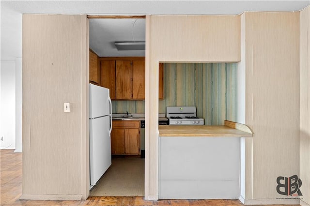 kitchen featuring sink and white appliances