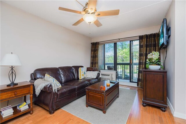 living room featuring light wood-type flooring and ceiling fan