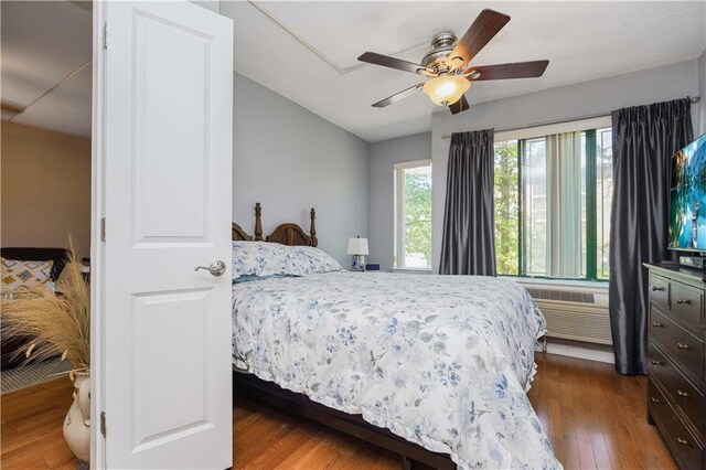 bedroom with hardwood / wood-style flooring and ceiling fan