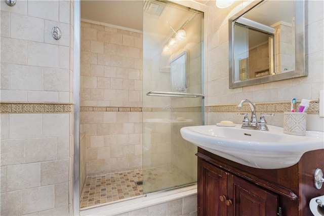 bathroom featuring backsplash, vanity, walk in shower, and tile walls