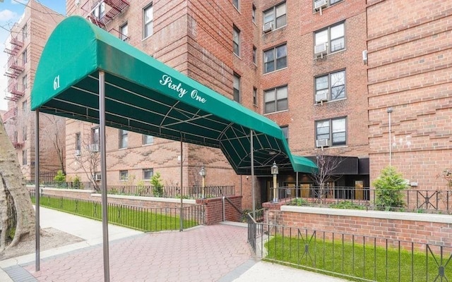 view of building exterior with fence