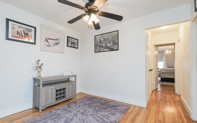 hall with a notable chandelier and light hardwood / wood-style flooring