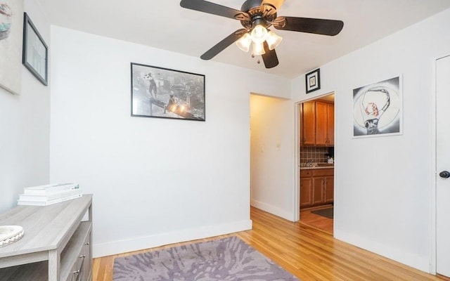 61 Oliver St Unit 2V, Brooklyn, NY 11209 - office area featuring a ceiling fan, light wood finished floors, and baseboards