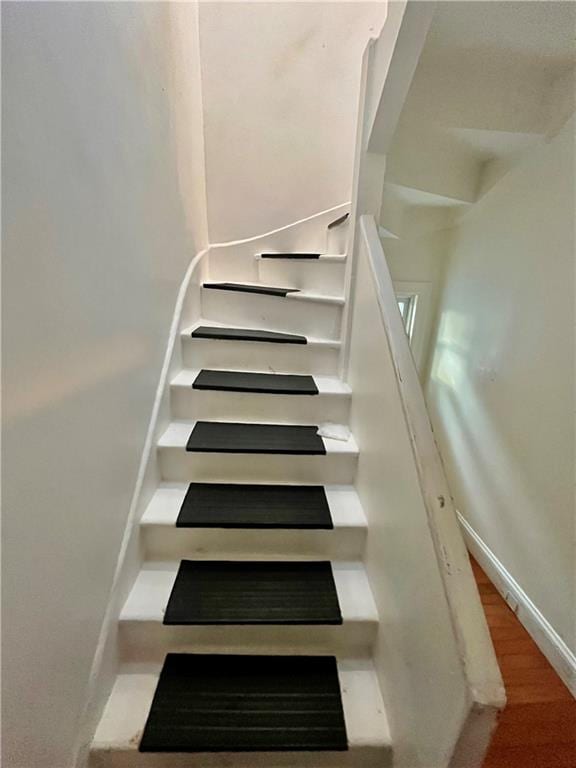 stairway featuring hardwood / wood-style flooring