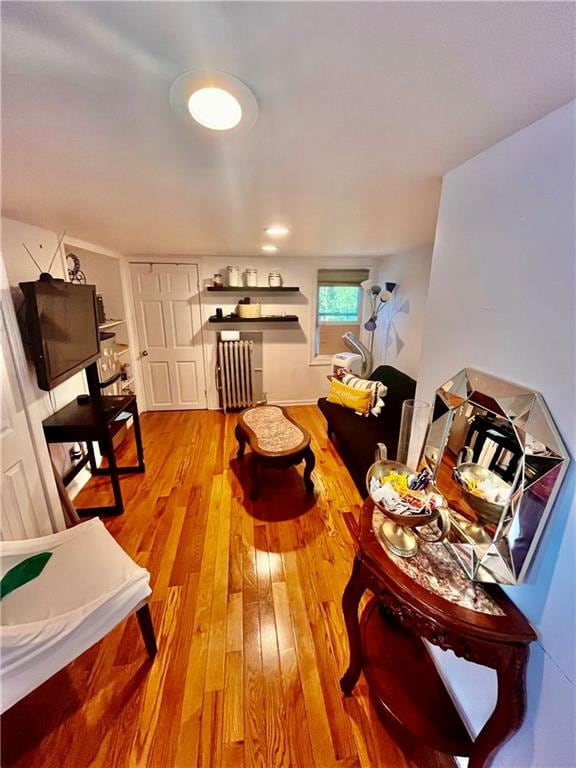 interior space with hardwood / wood-style flooring and radiator