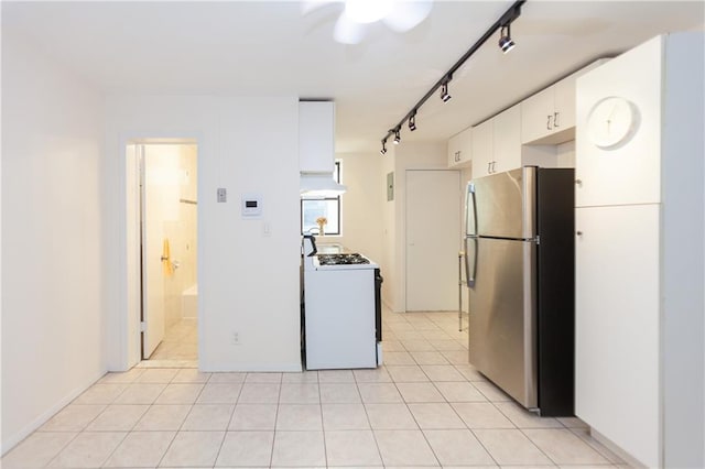 kitchen with white cabinetry, rail lighting, white range with gas cooktop, light tile patterned flooring, and stainless steel refrigerator