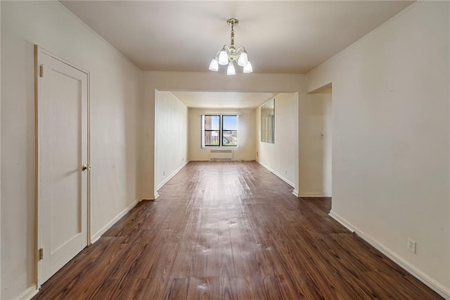 interior space with a chandelier, dark wood-style floors, and baseboards