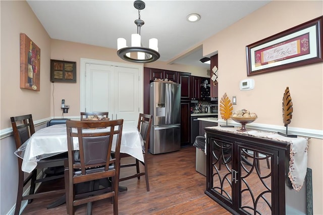 dining space featuring an inviting chandelier and dark hardwood / wood-style floors