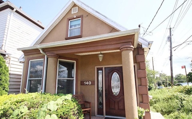 entrance to property featuring a porch