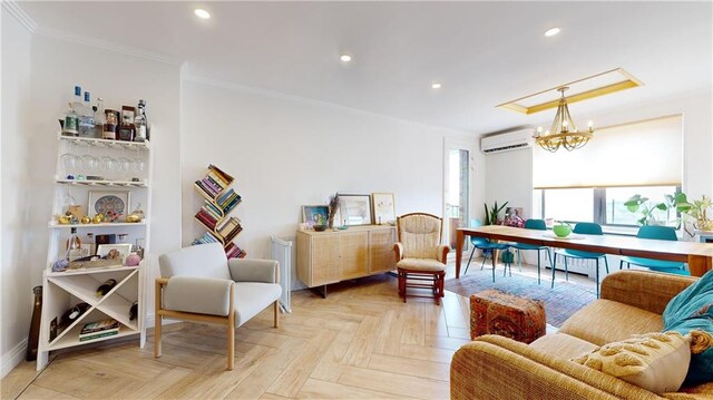 living room featuring an inviting chandelier, ornamental molding, a wall unit AC, and light parquet floors