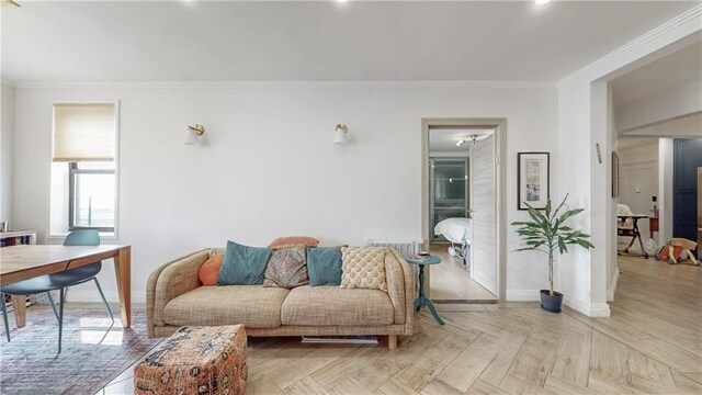 living room with crown molding and light parquet flooring