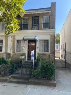 view of front of home featuring a balcony