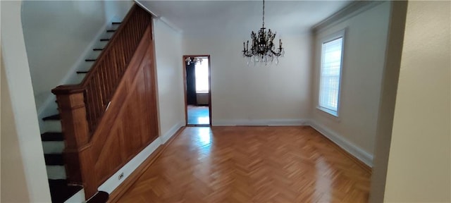 unfurnished dining area with light parquet floors and a chandelier