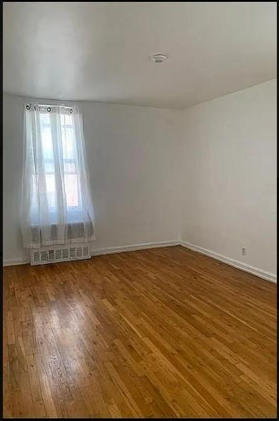 empty room featuring hardwood / wood-style flooring