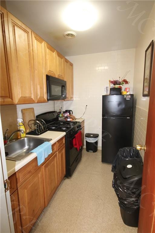 kitchen featuring black appliances and sink