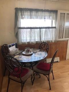 dining area featuring hardwood / wood-style flooring and a baseboard heating unit