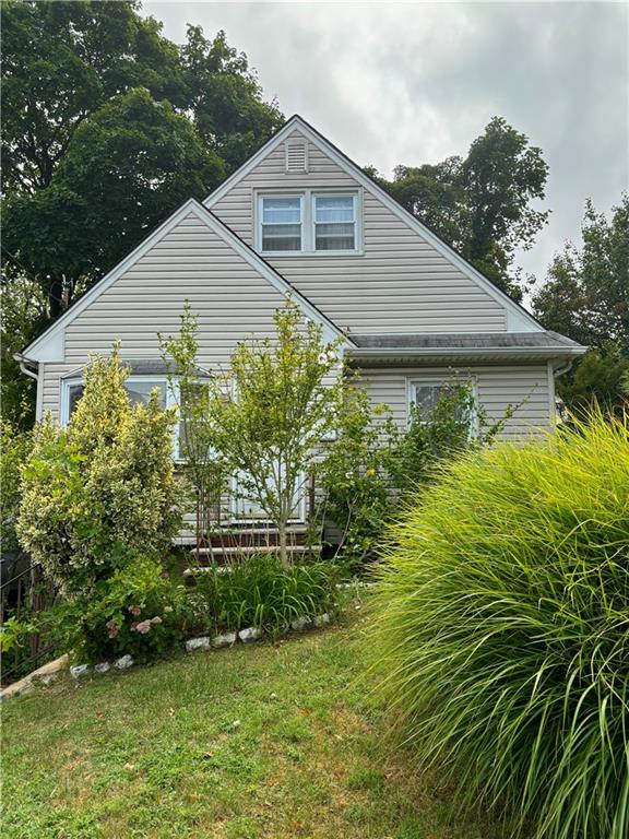 view of property exterior with a lawn