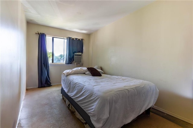 bedroom with cooling unit, baseboards, and carpet floors