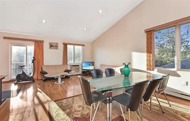 dining area with lofted ceiling and hardwood / wood-style floors