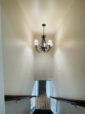 stairway featuring an inviting chandelier