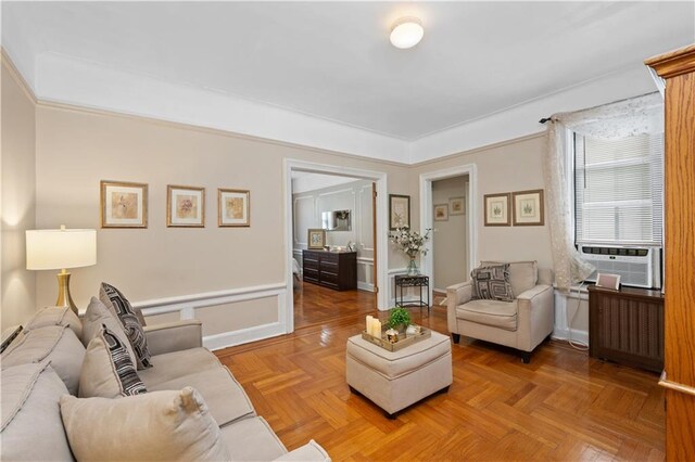 living room featuring cooling unit, radiator heating unit, and parquet flooring