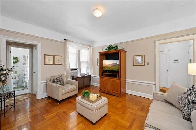 living room featuring cooling unit, radiator, and parquet flooring