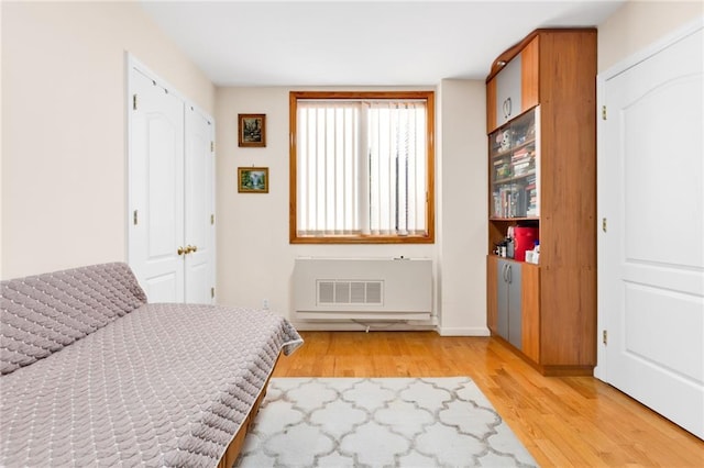 bedroom featuring light wood-type flooring and visible vents