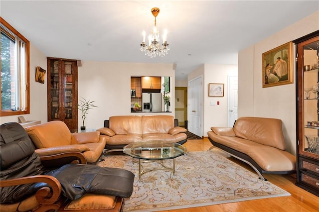 living area with an inviting chandelier and wood finished floors