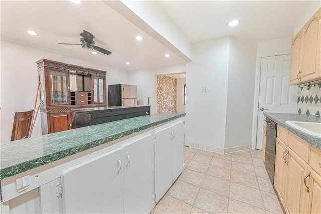 kitchen with sink, stainless steel fridge, ceiling fan, black dishwasher, and tasteful backsplash