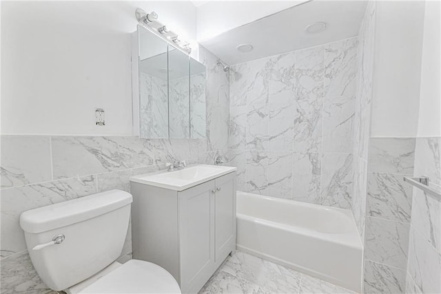 full bathroom featuring vanity, tiled shower / bath combo, tile walls, and toilet