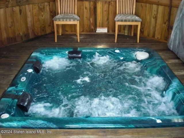 view of swimming pool featuring an indoor hot tub and a deck