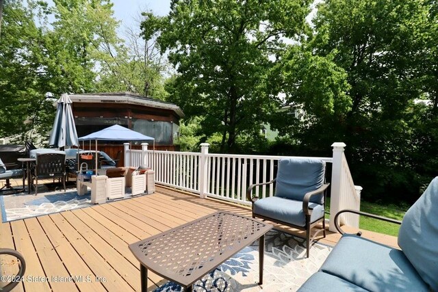 wooden terrace featuring a gazebo