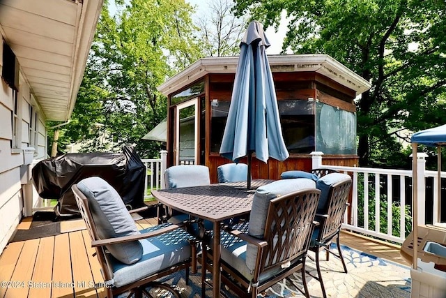 wooden deck with grilling area and outdoor dining area