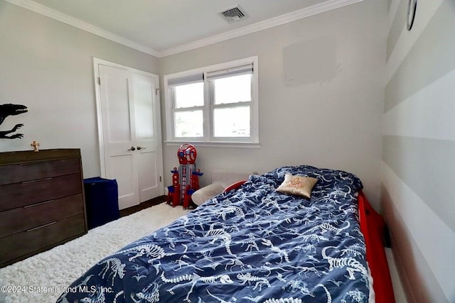 carpeted bedroom featuring visible vents and crown molding