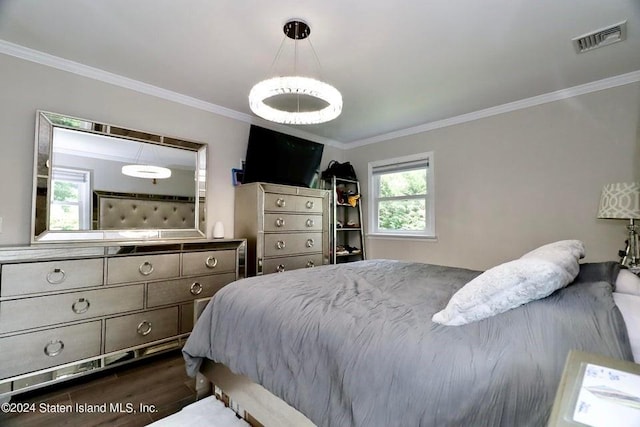 bedroom with dark hardwood / wood-style floors and crown molding