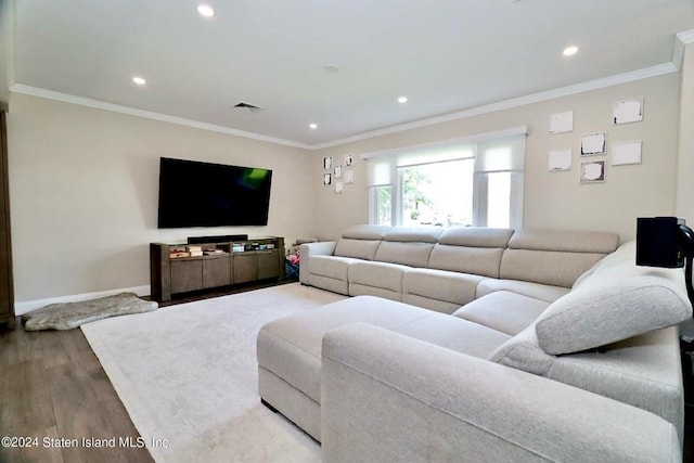 living room with crown molding and hardwood / wood-style floors