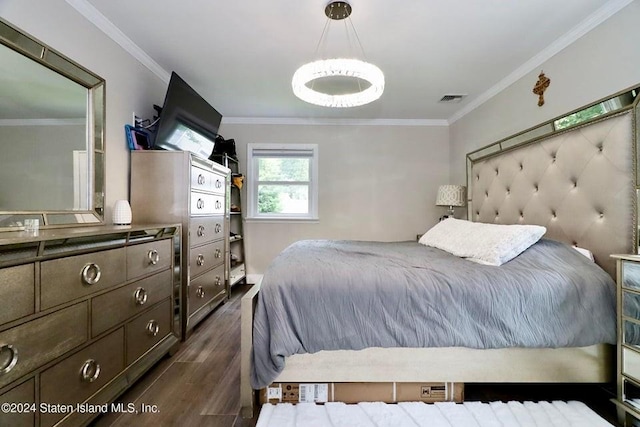 bedroom with visible vents, crown molding, and dark wood-style floors