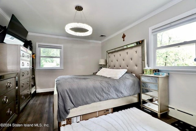 bedroom featuring a baseboard heating unit, dark hardwood / wood-style floors, and crown molding