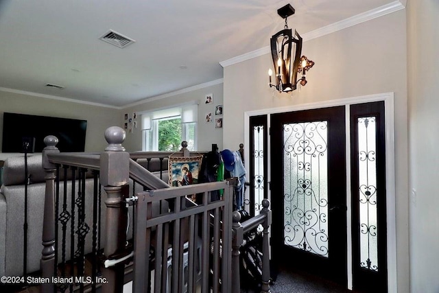 foyer featuring a notable chandelier and crown molding