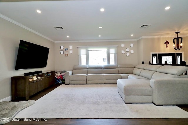 living room featuring crown molding and a chandelier