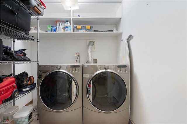 clothes washing area with washing machine and dryer