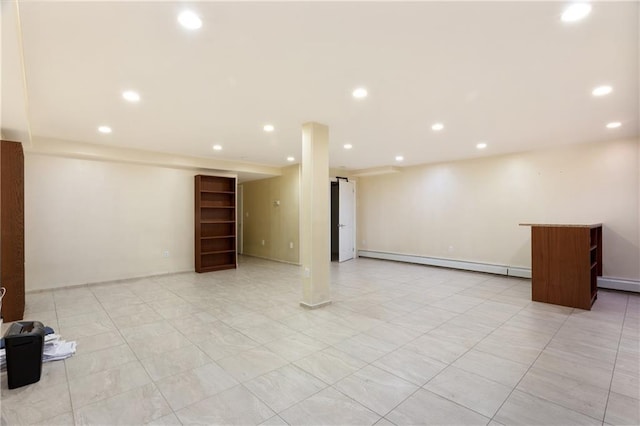 finished basement featuring a baseboard radiator and recessed lighting