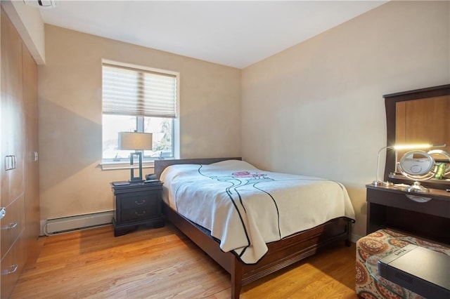 bedroom featuring light hardwood / wood-style flooring and baseboard heating