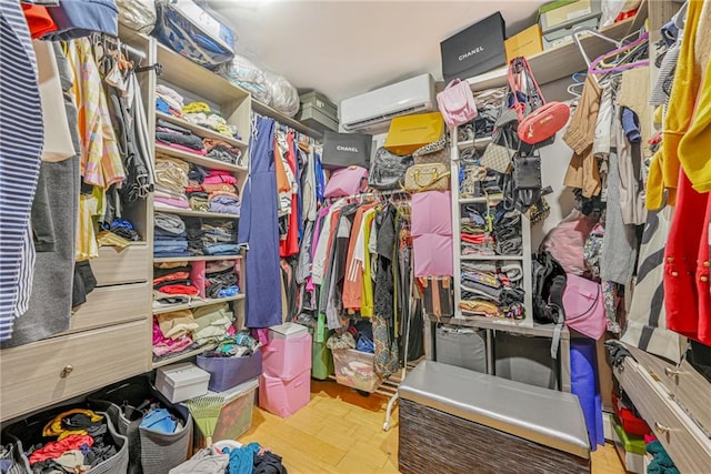 walk in closet featuring a wall unit AC