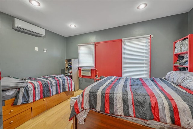 bedroom featuring wood-type flooring, an AC wall unit, and cooling unit