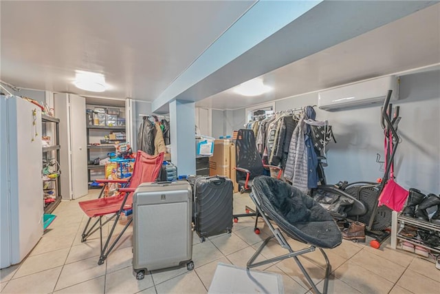 basement featuring a wall mounted AC and light tile patterned floors