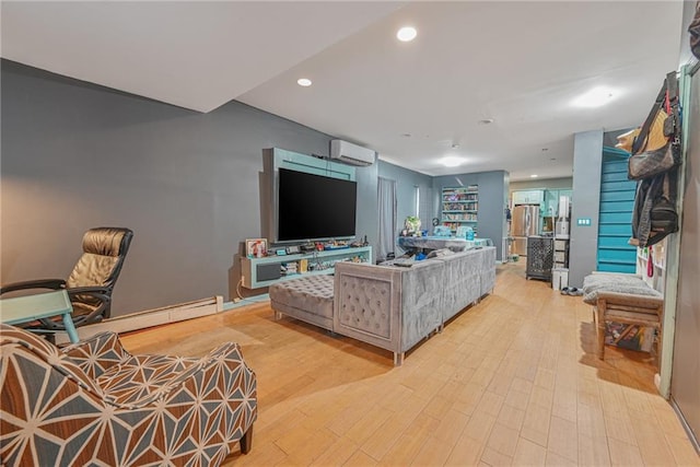 living room with an AC wall unit and light hardwood / wood-style floors