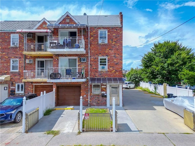 view of property featuring a balcony and a garage